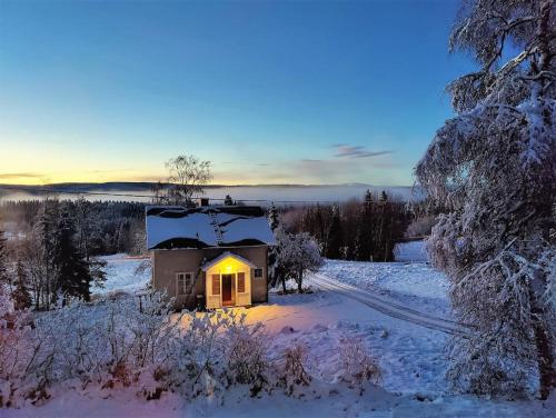 Mysigt hus med utsikt över fjäll och älv.